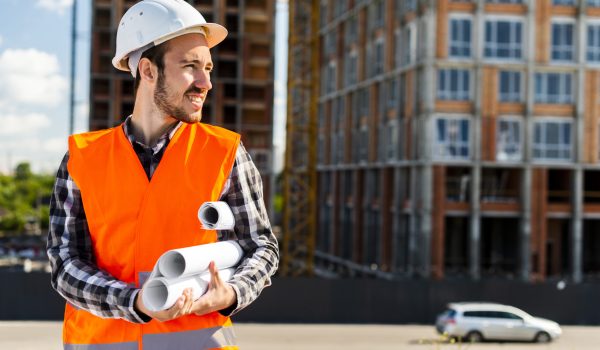 medium-shot-portrait-engineer-holding-plans